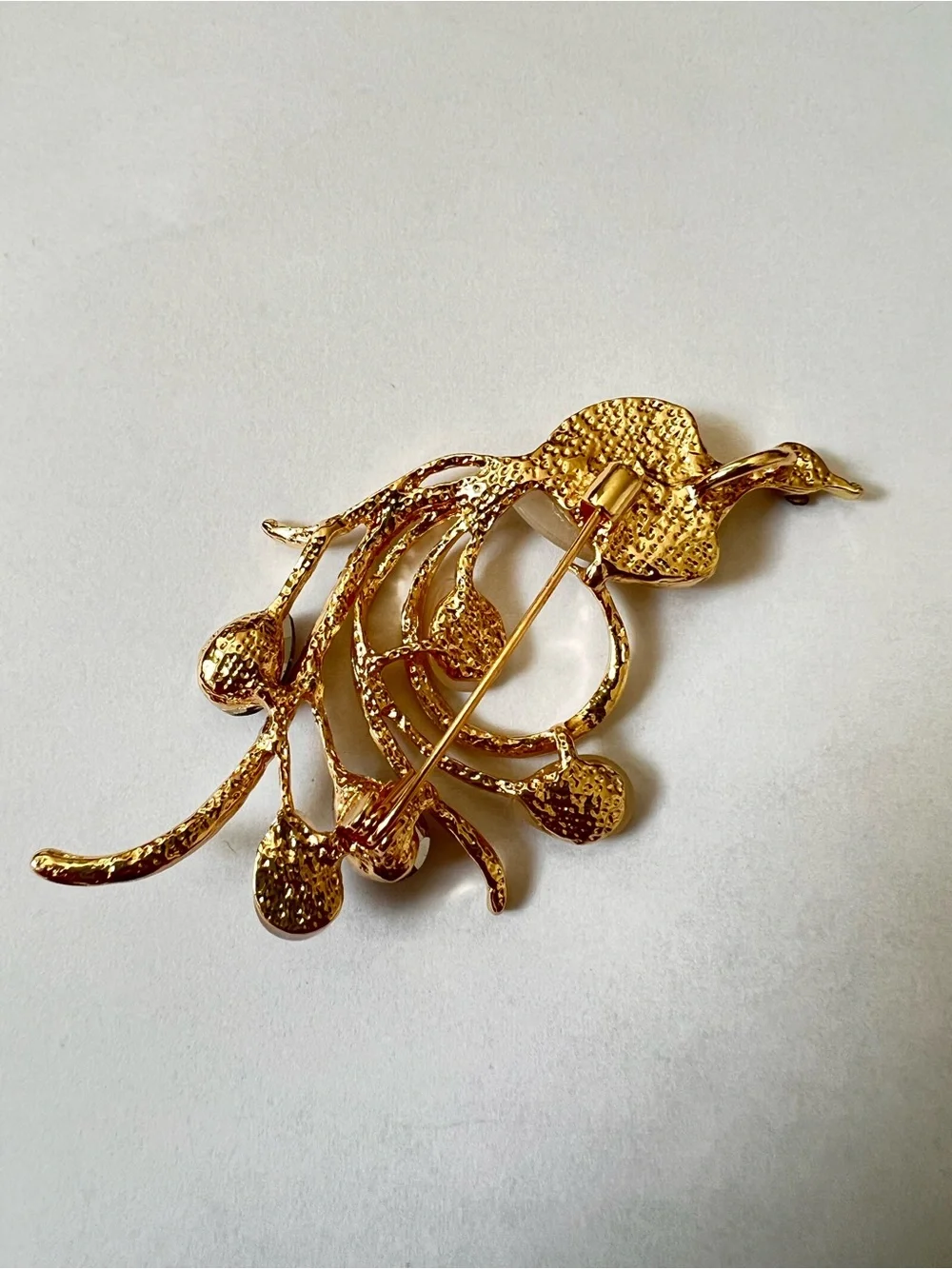Gold-Tone Floral Bird Brooch with Champagne and Garnet Stones